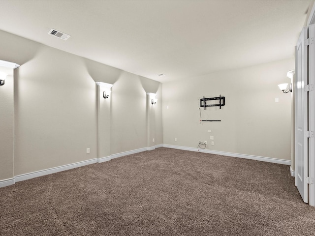 spare room with visible vents, baseboards, and carpet floors
