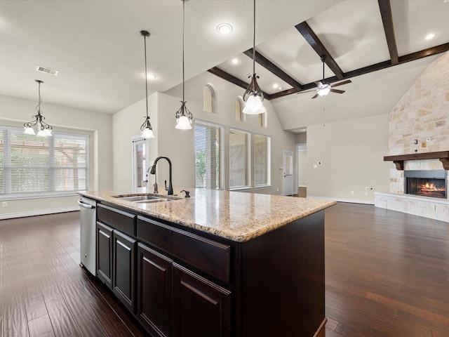 kitchen featuring a sink, dark wood finished floors, a ceiling fan, open floor plan, and stainless steel dishwasher
