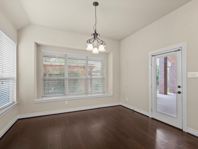 unfurnished dining area with dark wood-style flooring, baseboards, a chandelier, and a healthy amount of sunlight