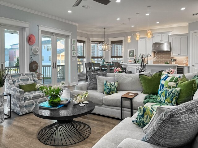 living room with a wealth of natural light, wood finished floors, and a ceiling fan