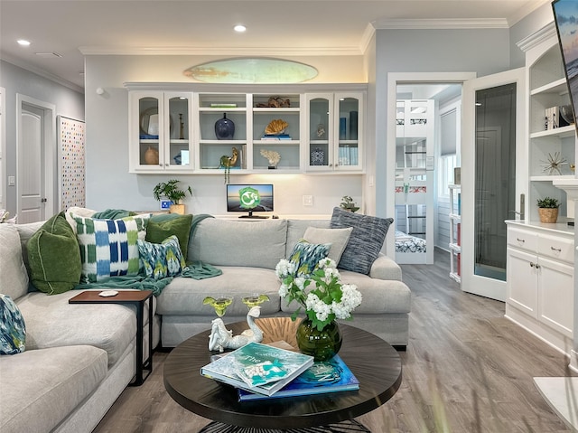 living area featuring crown molding, recessed lighting, and light wood-style floors