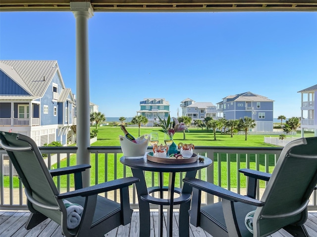 wooden deck featuring a residential view and a lawn