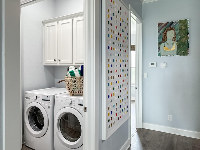 clothes washing area with washer and dryer, dark wood-style flooring, cabinet space, and baseboards