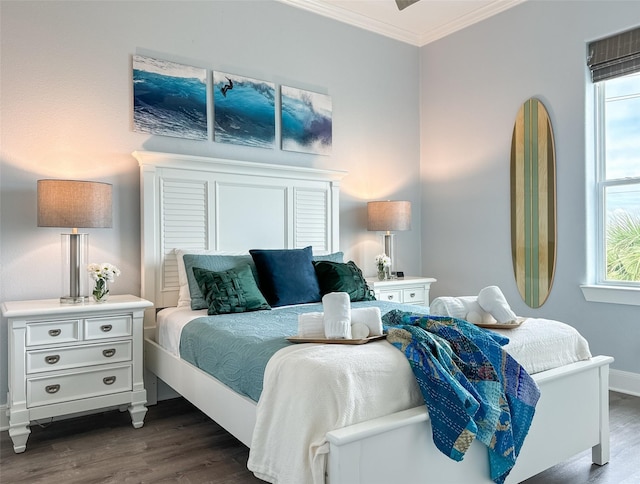 bedroom with dark wood-style floors, baseboards, and crown molding