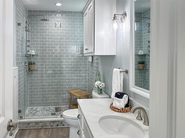 full bath with vanity, toilet, and a stall shower