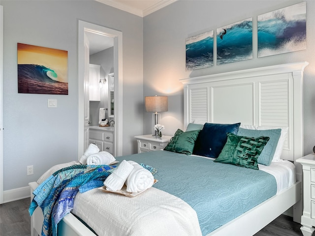bedroom featuring wood finished floors, crown molding, ensuite bath, and baseboards