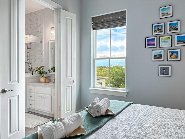 bedroom featuring a sink and connected bathroom