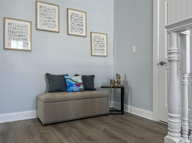 living area featuring baseboards and wood finished floors