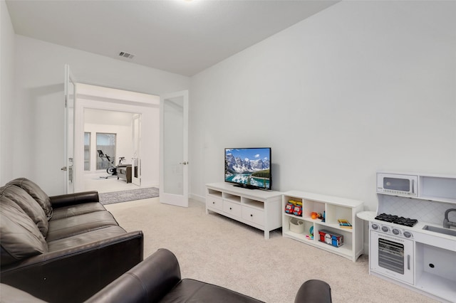living room featuring visible vents and carpet floors
