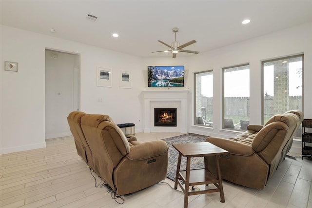 20514 Yearling Pasture Ln, Tomball, TX 77377 - living room featuring ceiling fan, a glass covered fireplace, recessed lighting, and light wood-style floors
