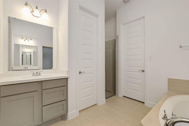 full bath featuring visible vents, vanity, a shower stall, and a bath