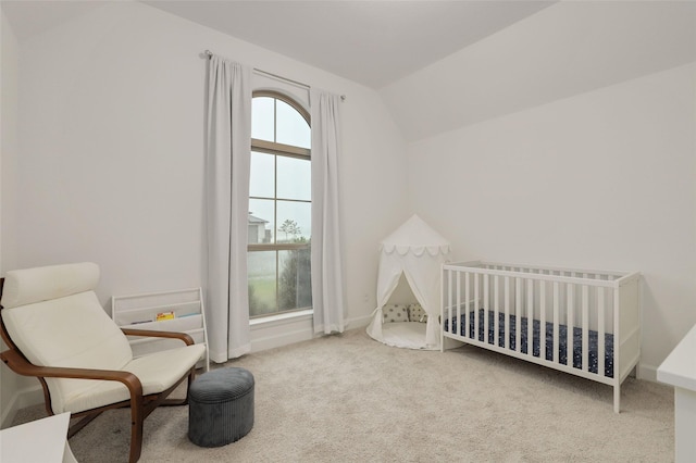 carpeted bedroom featuring lofted ceiling
