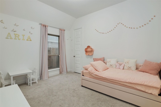 carpeted bedroom featuring vaulted ceiling and baseboards