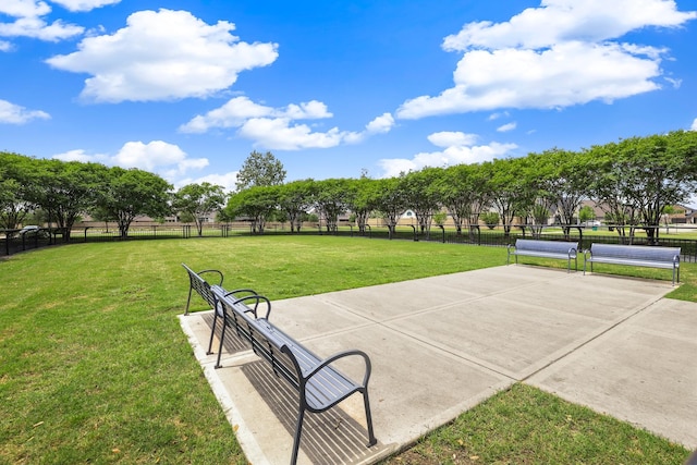 surrounding community featuring fence, a lawn, and a tennis court