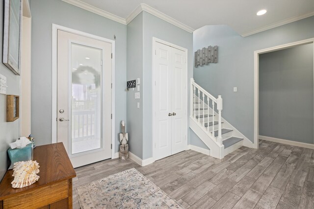 19427 Shores Dr, Galveston, TX 77554 - entrance foyer featuring recessed lighting, stairs, ornamental molding, light wood finished floors, and baseboards