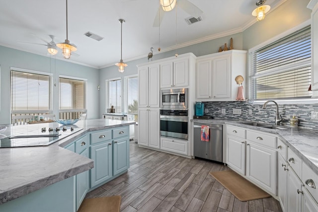 19427 Shores Dr, Galveston, TX 77554 - kitchen with ceiling fan, stainless steel appliances, visible vents, and a sink