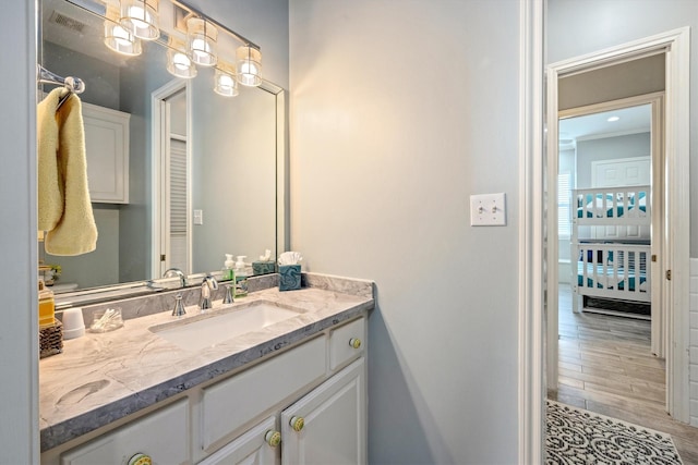 19427 Shores Dr, Galveston, TX 77554 - bathroom featuring wood finished floors, vanity, and visible vents