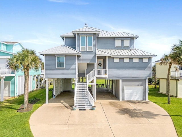 19427 Shores Dr, Galveston, TX 77554 - raised beach house featuring stairway, a standing seam roof, a garage, a carport, and concrete driveway