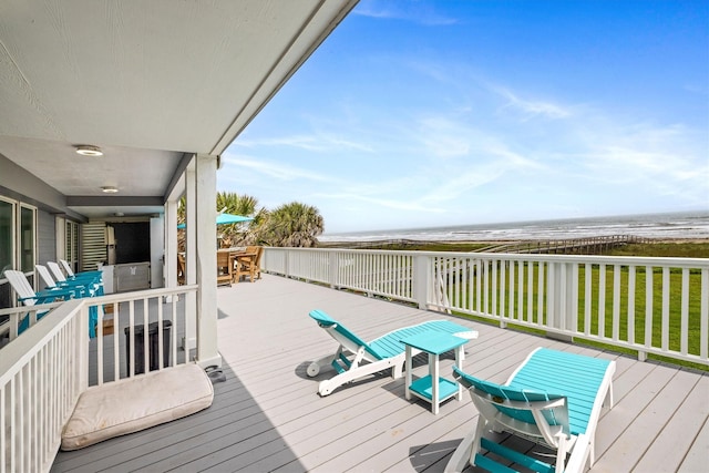 19427 Shores Dr, Galveston, TX 77554 - wooden deck with a beach view, outdoor dining area, and a water view