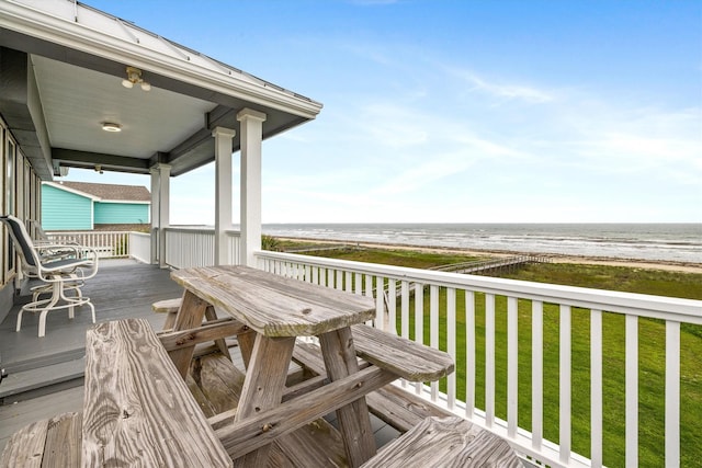 19427 Shores Dr, Galveston, TX 77554 - wooden deck with a lawn, a water view, and a view of the beach