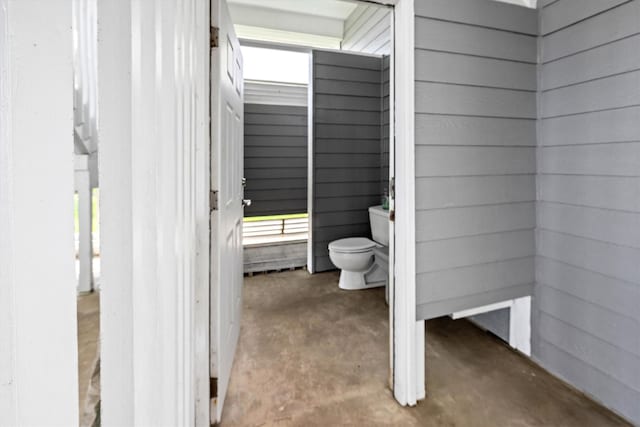 19427 Shores Dr, Galveston, TX 77554 - bathroom with toilet and unfinished concrete flooring