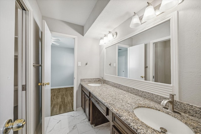 3206 Crossfell Rd, Spring, TX 77388 - bathroom with double vanity, marble finish floors, and baseboards