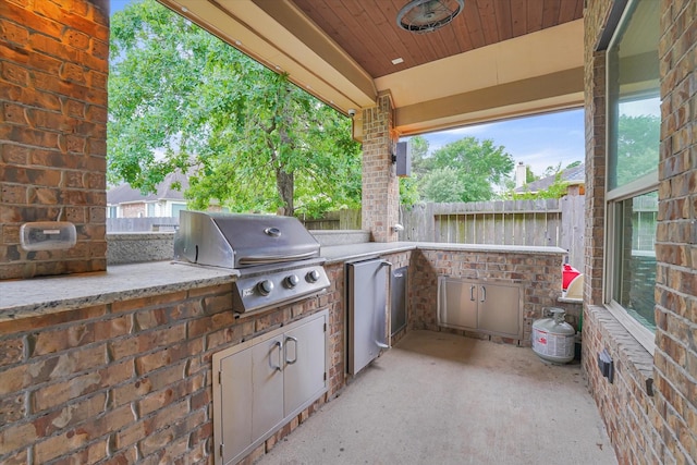 view of patio featuring grilling area, fence, and area for grilling
