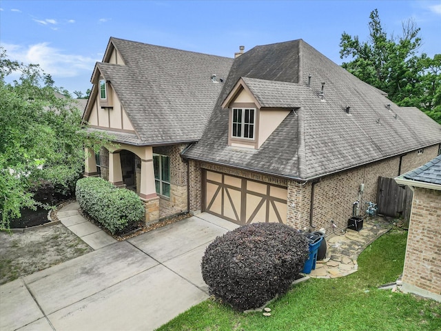 46 Chestnut Meadow Dr, Conroe, TX 77384 - view of front facade featuring a shingled roof, concrete driveway, a garage, brick siding, and fence