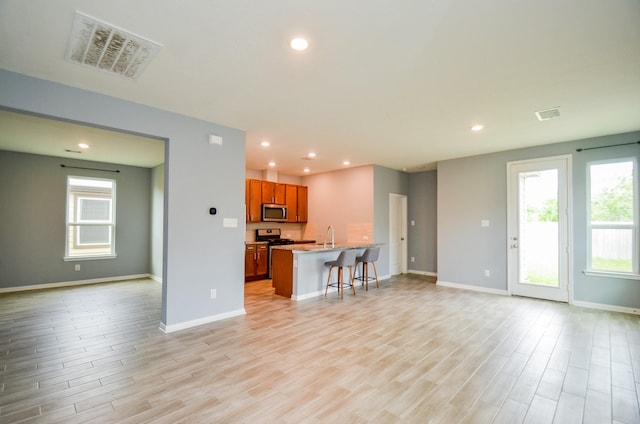 unfurnished living room featuring visible vents, light wood-style flooring, and recessed lighting