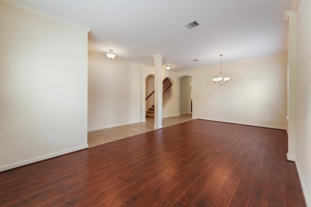 3635 Sunlight Hill Ln, Spring, TX 77386 - spare room featuring wood finished floors, visible vents, a notable chandelier, and arched walkways