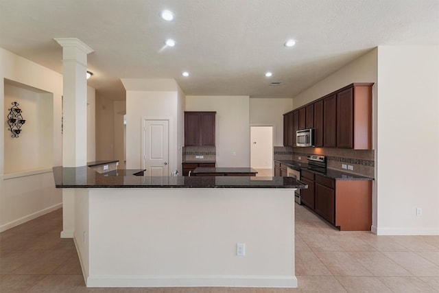 3635 Sunlight Hill Ln, Spring, TX 77386 - kitchen with light tile patterned floors, stainless steel appliances, a large island, and decorative backsplash