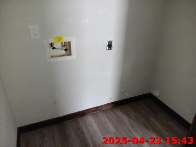 laundry room featuring washer hookup, wood finished floors, laundry area, and baseboards
