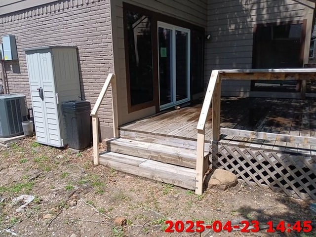wooden deck featuring central AC unit