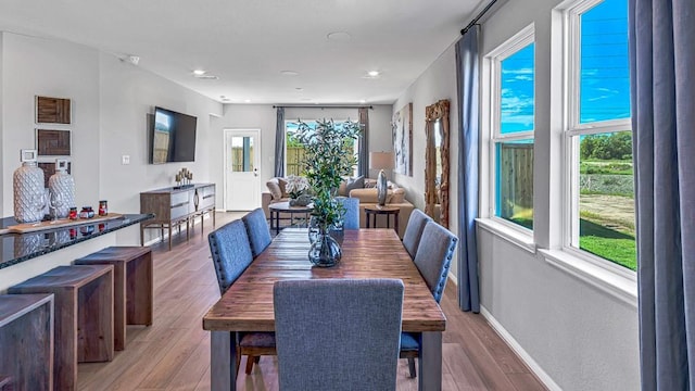 dining space with wood finished floors, recessed lighting, and baseboards