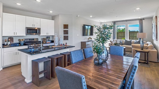 dining space featuring recessed lighting and light wood-style floors