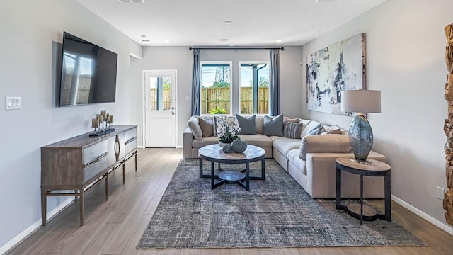 living room featuring wood finished floors and baseboards