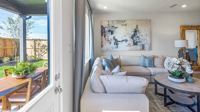 living room featuring recessed lighting, visible vents, and plenty of natural light