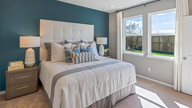 carpeted bedroom featuring baseboards
