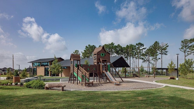 community playground featuring a lawn and fence