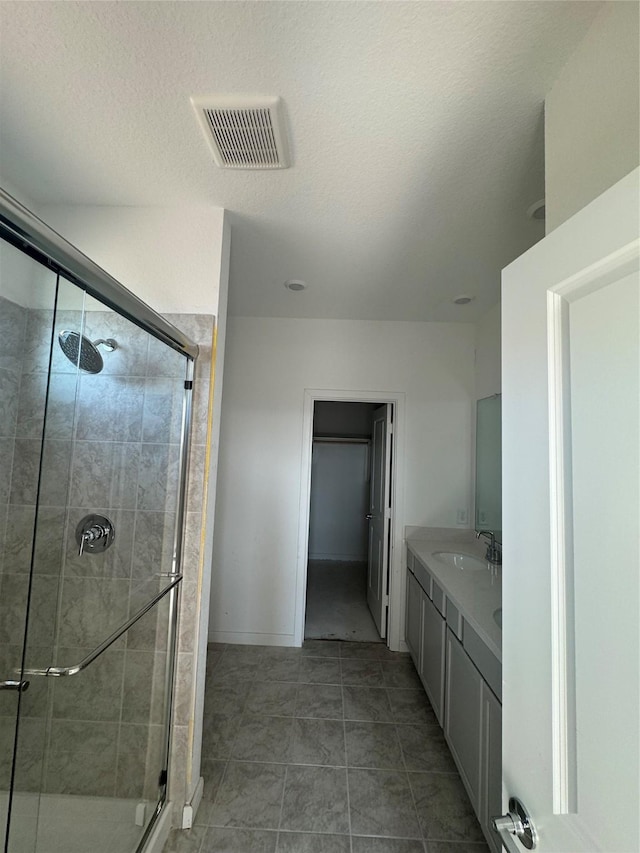 7707 Basil Ridge Dr, Cypress, TX 77433 - bathroom with a sink, double vanity, a shower stall, and visible vents