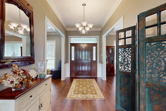 13671 Suzanne Pl, College Station, TX 77845 - entrance foyer with crown molding, a notable chandelier, and dark wood-type flooring