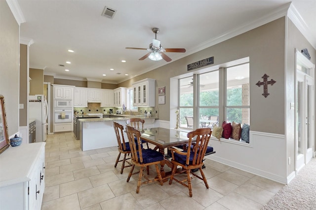 13671 Suzanne Pl, College Station, TX 77845 - dining space featuring visible vents, ornamental molding, ceiling fan, and light tile patterned floors
