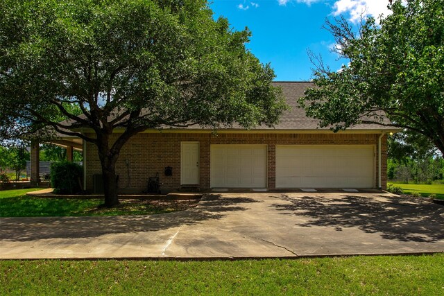 13671 Suzanne Pl, College Station, TX 77845 - view of front facade with driveway, a garage, and brick siding