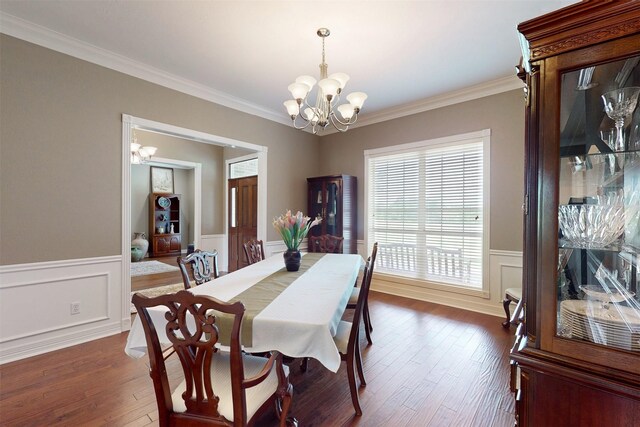 13671 Suzanne Pl, College Station, TX 77845 - dining area featuring wainscoting, a notable chandelier, dark wood-style flooring, and crown molding