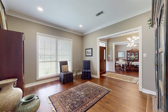 13671 Suzanne Pl, College Station, TX 77845 - living area with recessed lighting, an inviting chandelier, crown molding, visible vents, and wood finished floors
