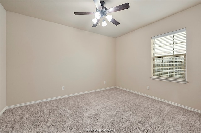 carpeted spare room featuring a ceiling fan, lofted ceiling, and baseboards