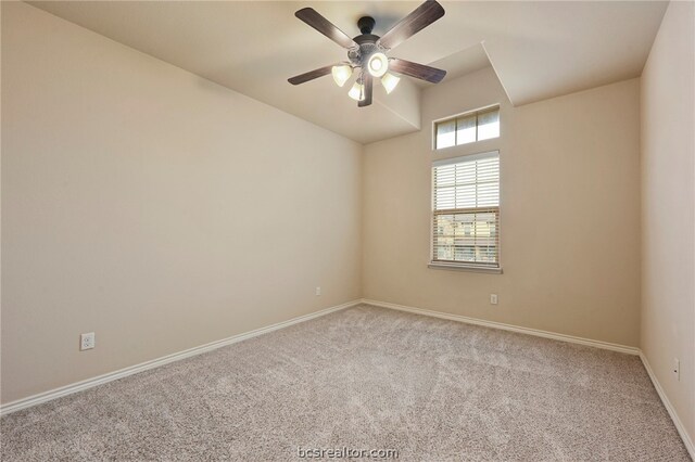 carpeted spare room with baseboards, a ceiling fan, and lofted ceiling