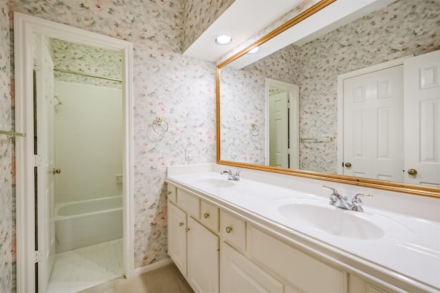 13727 Aspen Cove Dr, Houston, TX 77077 - full bathroom with wallpapered walls, double vanity, and shower / bathtub combination