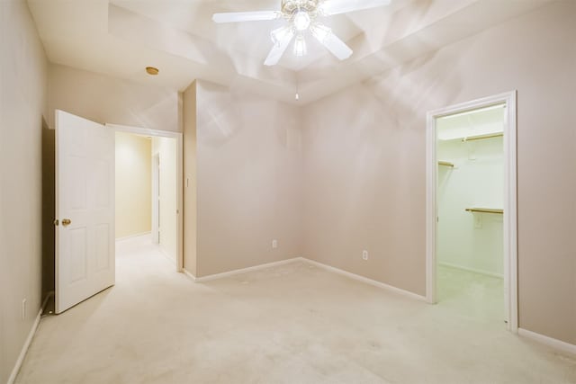 13727 Aspen Cove Dr, Houston, TX 77077 - unfurnished bedroom with light carpet, a walk in closet, ceiling fan, baseboards, and a closet