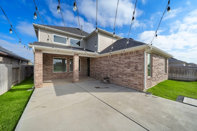 back of property with a patio area, a fenced backyard, and brick siding